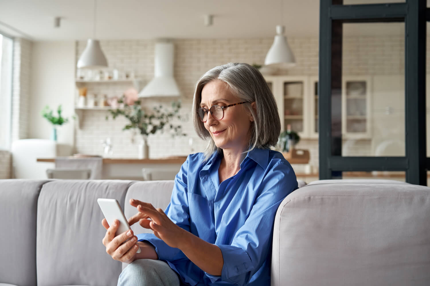 Fast bridging loans in Melbourne — apply online in minutes Melbourne homeowner reviewing her bridging loan application on a smartphone from her living room